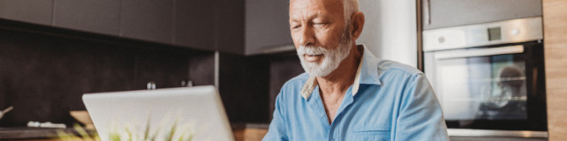 Man submitting a mental health claim on laptop at home.