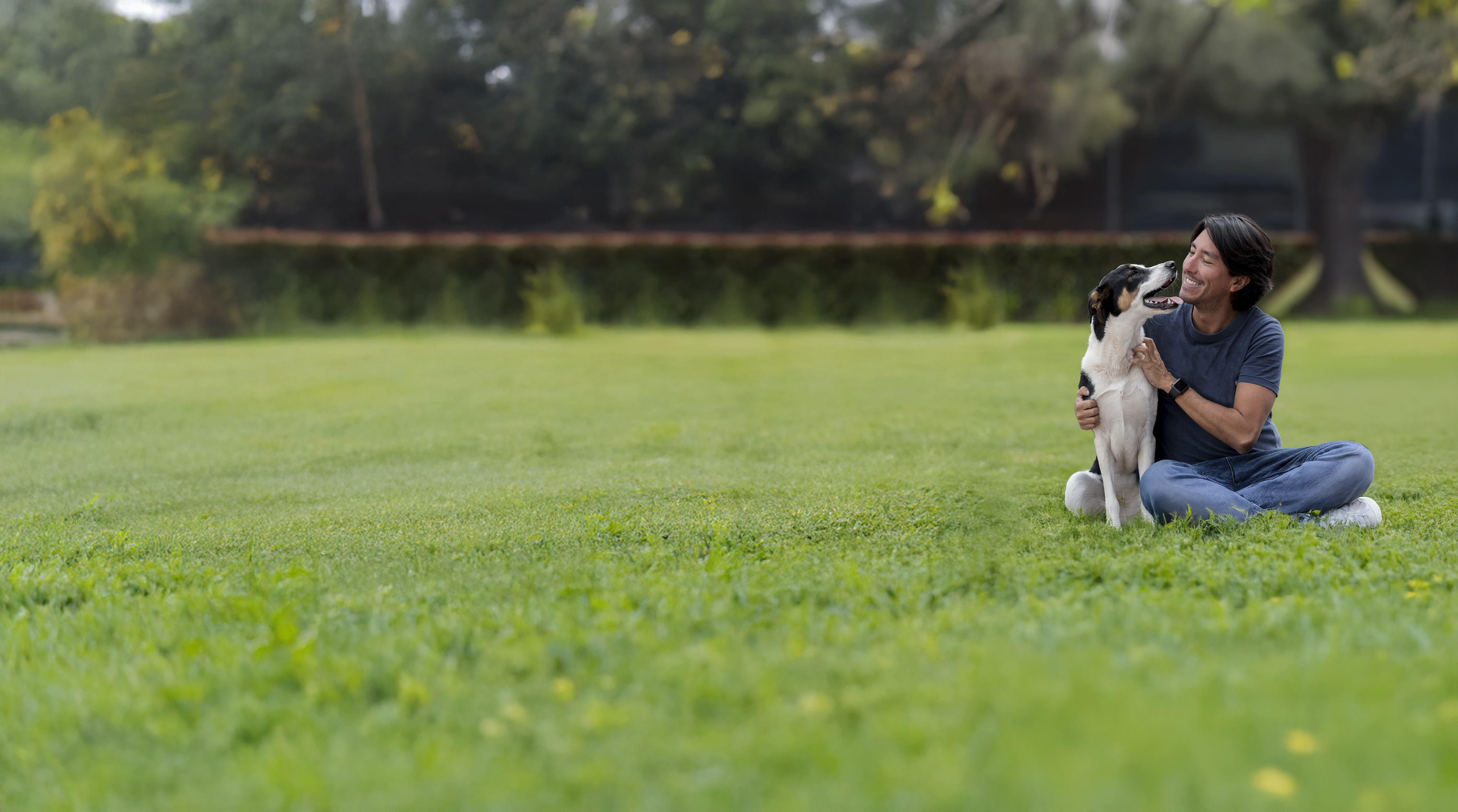 hopeful man smiling with his dog outside